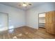 Well-lit bedroom showcasing wood floors, ceiling fan, and wood door closet at 37615 N Tranquil Trl, Carefree, AZ 85377