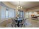 Dining area with a modern chandelier, round table, and plenty of natural light at 37615 N Tranquil Trl, Carefree, AZ 85377