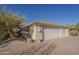 View of a spacious three-car garage featuring a brick driveway at 37615 N Tranquil Trl, Carefree, AZ 85377