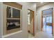 Hallway with built in niche art and openings leading to the bathroom and dining room at 37615 N Tranquil Trl, Carefree, AZ 85377