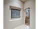 Hallway with inset art, wooden door frame and neutral paint at 37615 N Tranquil Trl, Carefree, AZ 85377