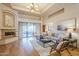 Bright and airy living room with fireplace, hardwood floors, and sliding glass doors to the patio at 37615 N Tranquil Trl, Carefree, AZ 85377