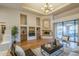 Bright living room with hardwood floors, fireplace, and sliding glass doors to the patio at 37615 N Tranquil Trl, Carefree, AZ 85377