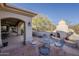 Desert property with an outdoor fireplace and dining area with a seating for four at 37615 N Tranquil Trl, Carefree, AZ 85377