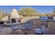 Charming patio features a stucco fireplace, outdoor grill, and desert landscaping at 37615 N Tranquil Trl, Carefree, AZ 85377