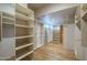 Spacious walk-in closet with custom shelving and ample storage space at 37615 N Tranquil Trl, Carefree, AZ 85377