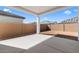 Covered back patio with concrete, overlooking a dirt yard and block wall fencing at 42140 N Golden Trl, San Tan Valley, AZ 85140