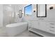 Bright and spacious bathroom with a soaking tub, dual vanities, and a glass enclosed shower at 42140 N Golden Trl, San Tan Valley, AZ 85140