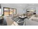 Modern living room with an open layout connecting to the kitchen and dining area, creating a cohesive living space at 42140 N Golden Trl, San Tan Valley, AZ 85140