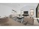 Bright living room featuring vaulted ceilings, modern furniture, and seamless indoor-outdoor flow at 42140 N Golden Trl, San Tan Valley, AZ 85140