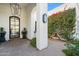 Elegant entryway with a glass front door, fountain, and brick flooring at 6229 E Gold Dust Ave, Paradise Valley, AZ 85253