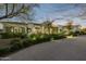 Elegant home exterior at dusk showcasing landscaping and a paved driveway at 6229 E Gold Dust Ave, Paradise Valley, AZ 85253