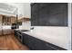 Modern kitchen with dark cabinetry, marble countertops, and stainless steel appliances at 6229 E Gold Dust Ave, Paradise Valley, AZ 85253