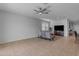 Open living room with a ceiling fan and tile flooring at 1057 W Chimes Tower Dr, Casa Grande, AZ 85122