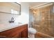 Bathroom with wood vanity, walk-in shower, and modern fixtures at 1721 S Shafer Dr, Tempe, AZ 85281