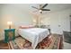 Well-lit bedroom with hardwood floors, ceiling fan, and a large mirror at 1721 S Shafer Dr, Tempe, AZ 85281