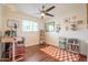 Bright bedroom with hardwood floors, a ceiling fan, and a workspace at 1721 S Shafer Dr, Tempe, AZ 85281