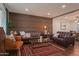 Modern living room with wood-paneled accent wall and leather sofas at 1721 S Shafer Dr, Tempe, AZ 85281