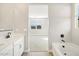 Bright bathroom featuring a double vanity, bathtub, and wood-look tile flooring at 17731 W Elm St, Goodyear, AZ 85395