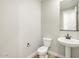 Small powder room with single pedestal sink and a mirror at 17731 W Elm St, Goodyear, AZ 85395