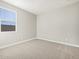 Bright bedroom with neutral carpet, window, and fresh paint at 17731 W Elm St, Goodyear, AZ 85395