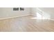 Bright bedroom featuring wood-look tile flooring at 17731 W Elm St, Goodyear, AZ 85395