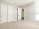 Bedroom featuring sliding closet doors, neutral carpet and fresh paint at 17731 W Elm St, Goodyear, AZ 85395