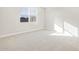 Bedroom with carpeted flooring, white walls, and a window at 17731 W Elm St, Goodyear, AZ 85395