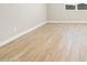 Bright room with wood-style tile flooring and baseboards at 17731 W Elm St, Goodyear, AZ 85395