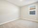 Bedroom featuring neutral carpet, window, and fresh paint at 17731 W Elm St, Goodyear, AZ 85395