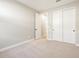 This bedroom boasts neutral walls, carpet and a closet with sliding doors at 17731 W Elm St, Goodyear, AZ 85395