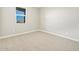 Well-lit bedroom with neutral carpet, window, and fresh paint at 17731 W Elm St, Goodyear, AZ 85395