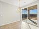 Dining area with sliding glass doors to backyard patio and modern chandelier at 17731 W Elm St, Goodyear, AZ 85395