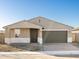 Charming single-story home with a brick driveway, two-car garage, and neutral color scheme at 17731 W Elm St, Goodyear, AZ 85395