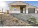 Single-story home with desert landscaping, covered porch, and neutral color scheme at 17731 W Elm St, Goodyear, AZ 85395