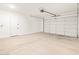 A clean, spacious garage with a concrete floor and a white door for vehicle entry at 17731 W Elm St, Goodyear, AZ 85395