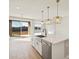 Bright kitchen with stainless steel appliances, farmhouse sink and modern pendant lighting at 17731 W Elm St, Goodyear, AZ 85395