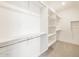 Walk-in closet with extensive shelving and hanging rods providing ample storage at 17731 W Elm St, Goodyear, AZ 85395