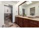 Bathroom with double sinks, stone countertops, and large mirror at 26223 N Bravo Ln, Rio Verde, AZ 85263