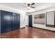 Bedroom with terracotta floors, ceiling fan, and built-in mirror at 26223 N Bravo Ln, Rio Verde, AZ 85263