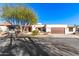 Spanish style home with landscaped front yard and two-car garage at 26223 N Bravo Ln, Rio Verde, AZ 85263