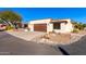 Spanish style home with wood garage door and desert landscaping at 26223 N Bravo Ln, Rio Verde, AZ 85263