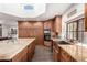 Kitchen with granite countertops, farmhouse sink, and wooden cabinets at 26223 N Bravo Ln, Rio Verde, AZ 85263