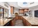 Kitchen with granite countertops, farmhouse sink, and wooden cabinets at 26223 N Bravo Ln, Rio Verde, AZ 85263