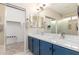 Double vanity bathroom with blue cabinets and a walk-in shower at 30636 N Royal Oak Way, San Tan Valley, AZ 85143