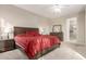 King-size bed in a well-lit bedroom with ensuite access at 30636 N Royal Oak Way, San Tan Valley, AZ 85143