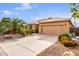 House exterior with a two-car garage and mature landscaping at 30636 N Royal Oak Way, San Tan Valley, AZ 85143