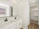 Bathroom showing a double sink vanity, and a closet with shelving at 4820 N 177Th Dr, Goodyear, AZ 85395