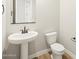 Bathroom showcasing a pedestal sink, a modern toilet, and stylish fixtures at 4820 N 177Th Dr, Goodyear, AZ 85395