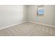 Cozy bedroom featuring neutral carpet, base trim, one window, and light gray walls at 4820 N 177Th Dr, Goodyear, AZ 85395